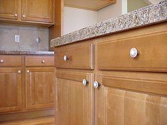 Granite counters, laminate counters, full tile backsplash, Birch cabinetry, Character Birch hardwood, custom knobs...