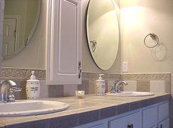 Master bath vanity features two sinks, tiled counter top & surround, beveled mirrors, custom medicine cabinet...